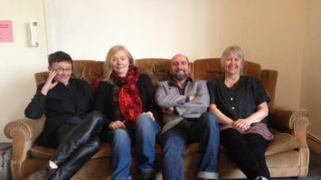 4 members of the X6 collective sit on a sofa in the CDS lounge