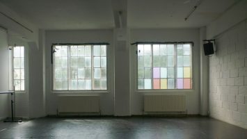 the side wall of the research studio, with bright, colourful windows