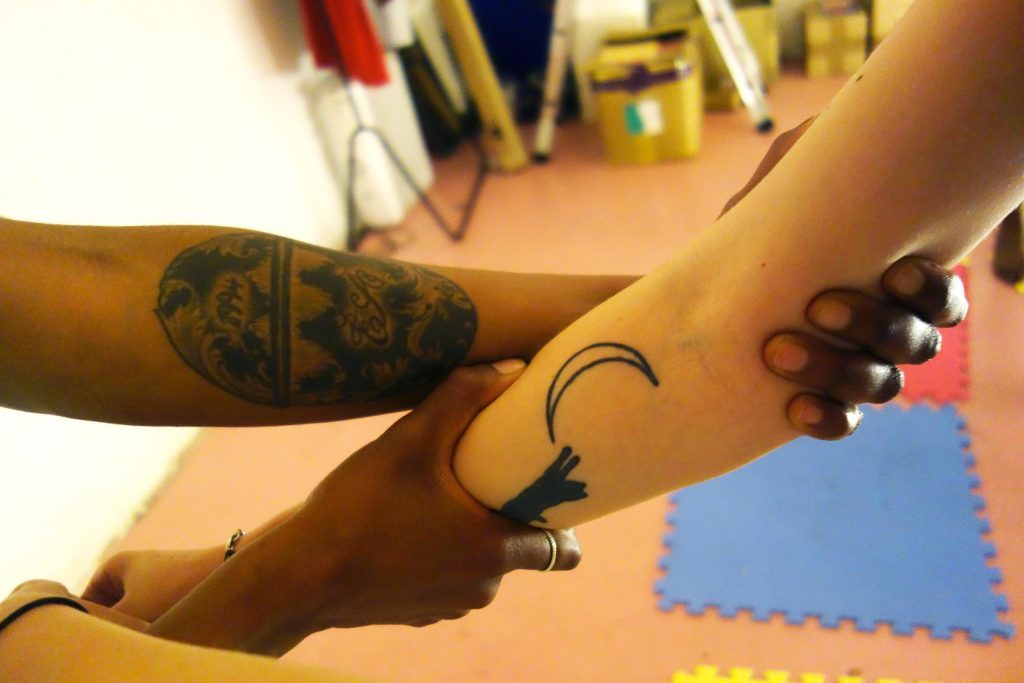 two people hold each others arms