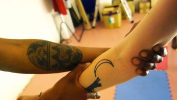 two people hold each others arms