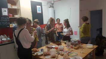 People meet and chat over food in the CDS Kitchen